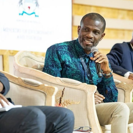 Mark Okraku Mantey Photo of man speaking at a panel.
